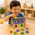 Niño colocando figuras en casita didáctica educativa de madera